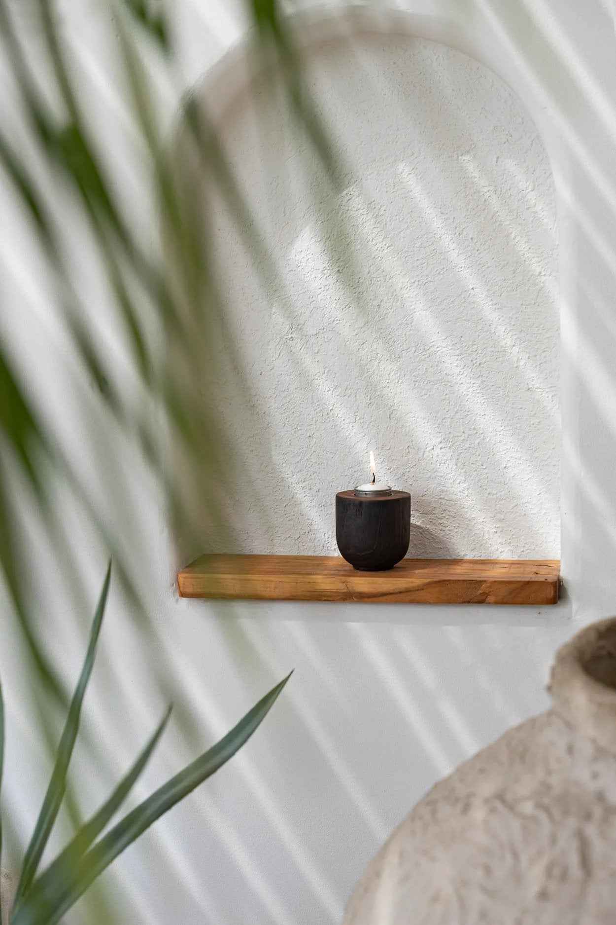 Teak wood tealight candle holder in a sleek black finish