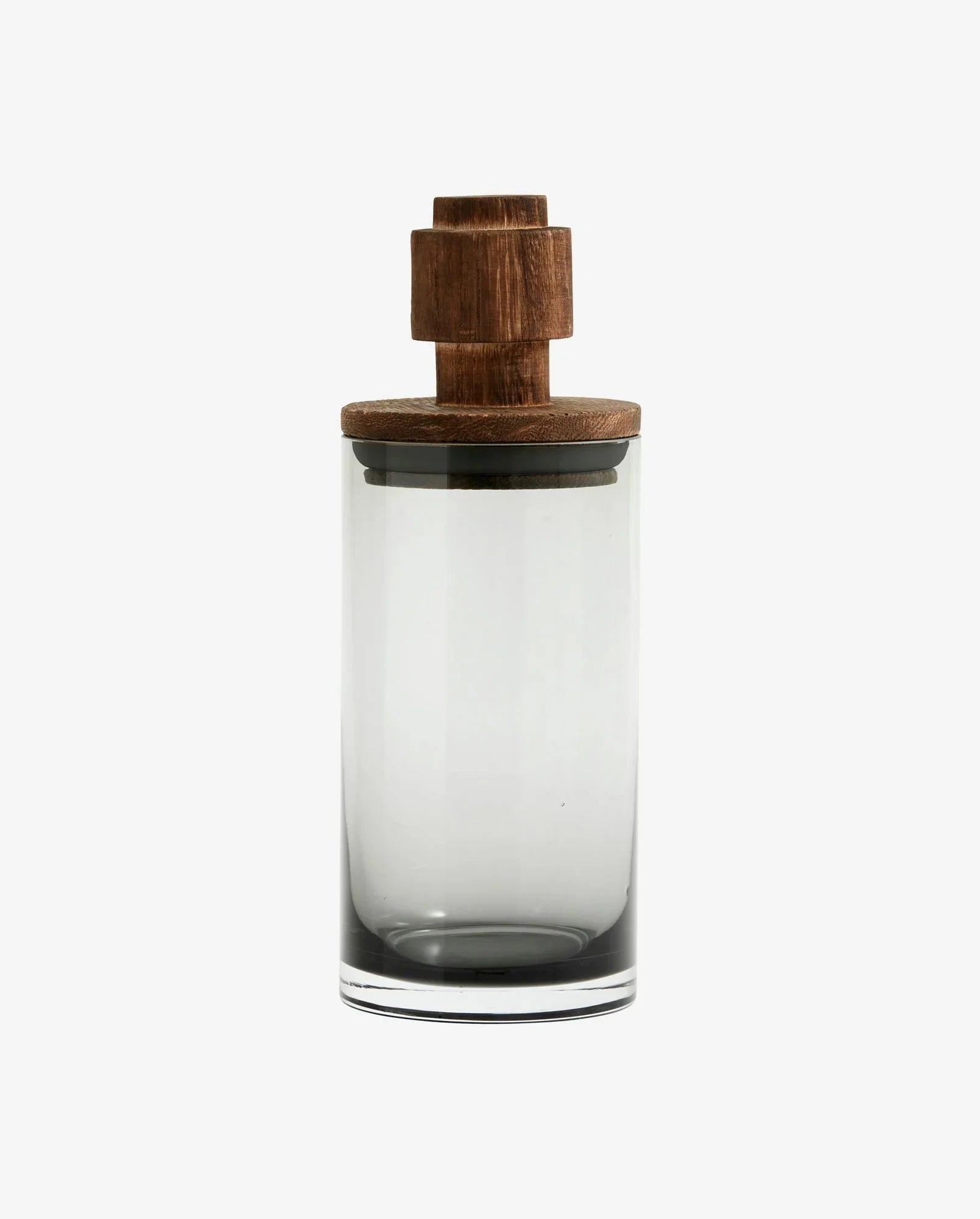 Clear glass container with dark wood lid featuring a geometric knob on white background