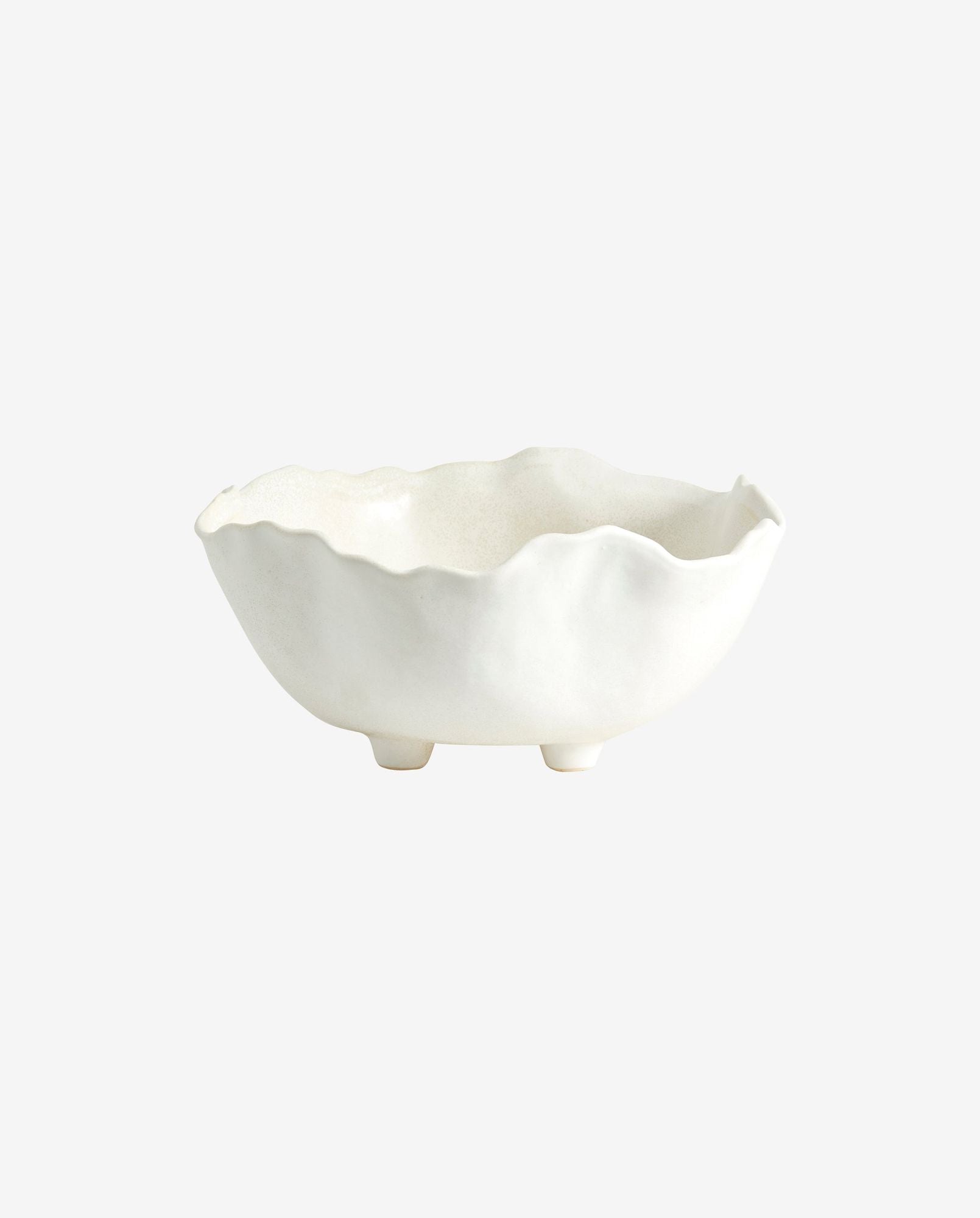 White ceramic bowl with irregular wavy edges and small feet on plain background