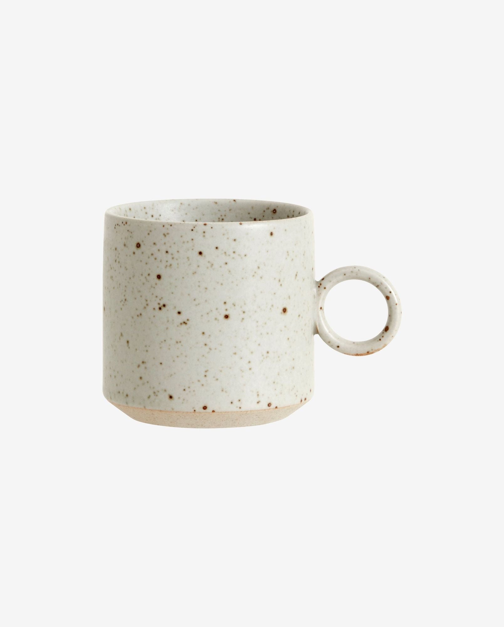 Speckled ceramic coffee mug with round handle and natural beige tones on white background
