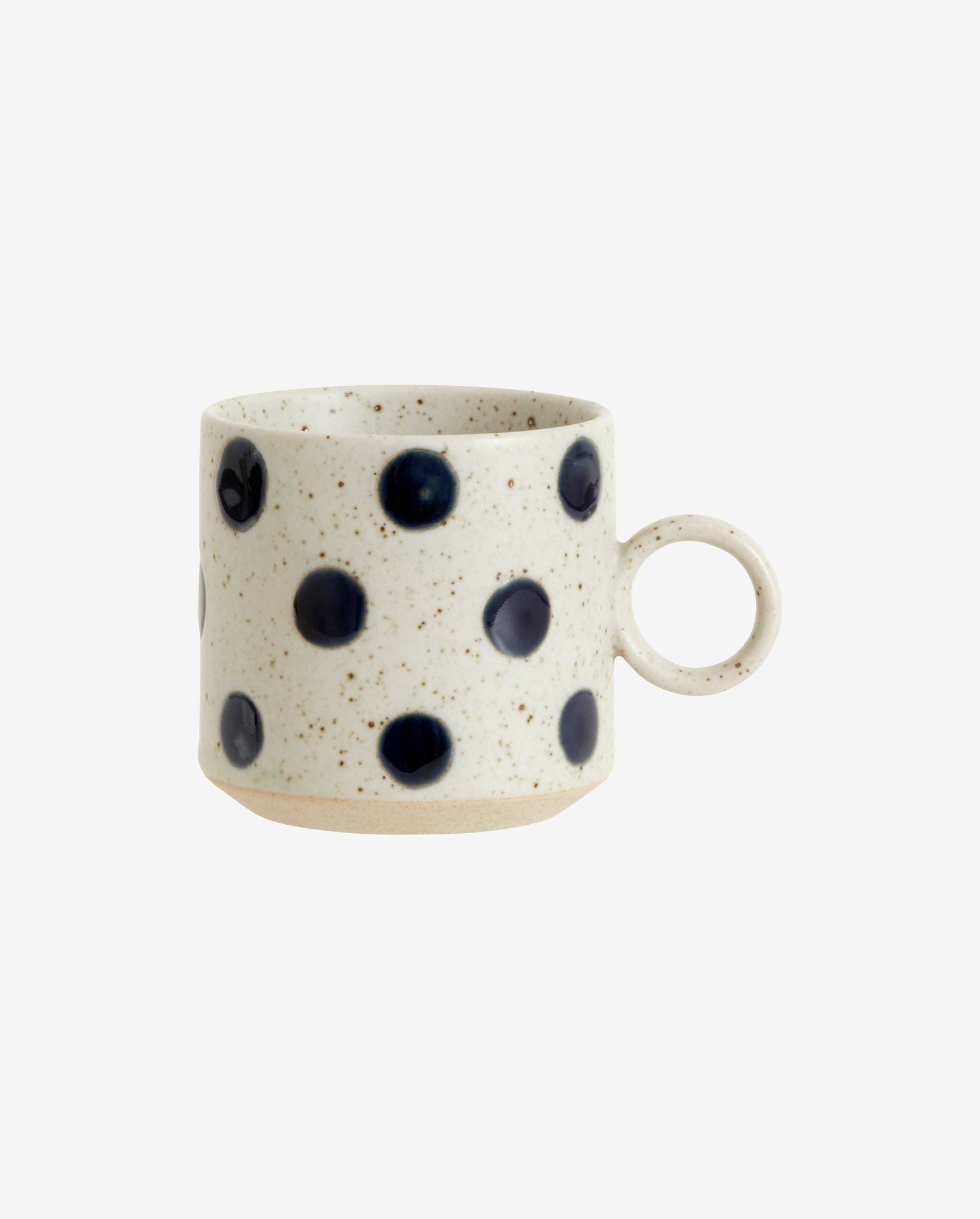 white ceramic mug with dark blue polka dots and speckled design, round handle