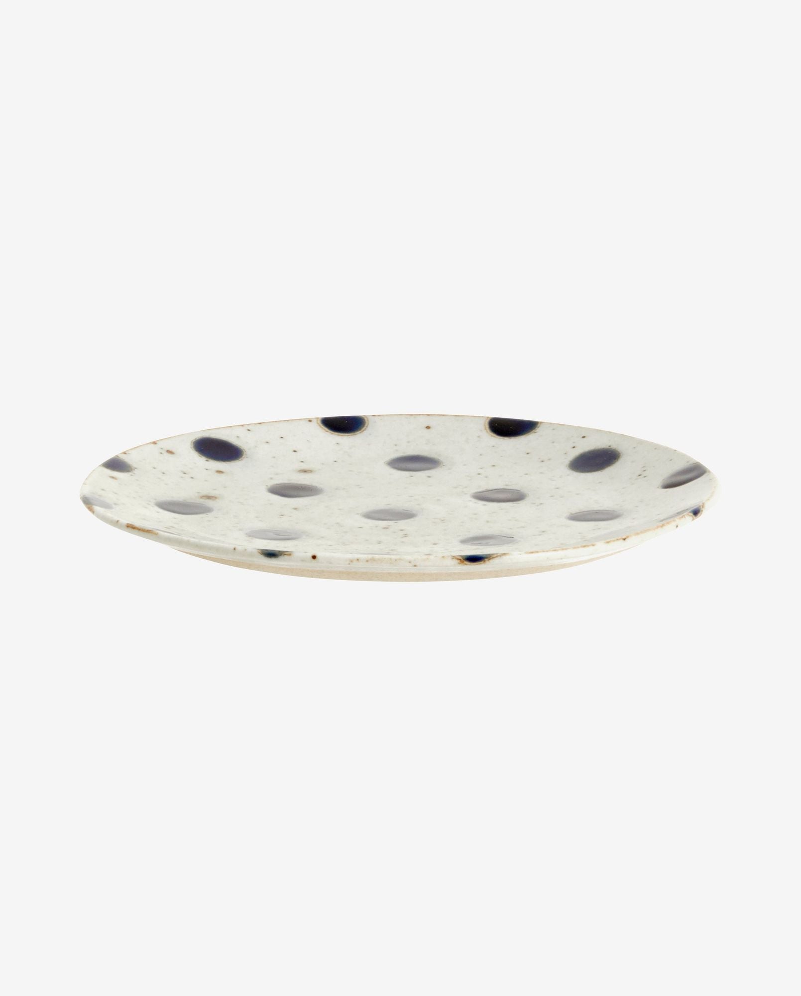 White ceramic plate with irregular black polka dots and speckled design