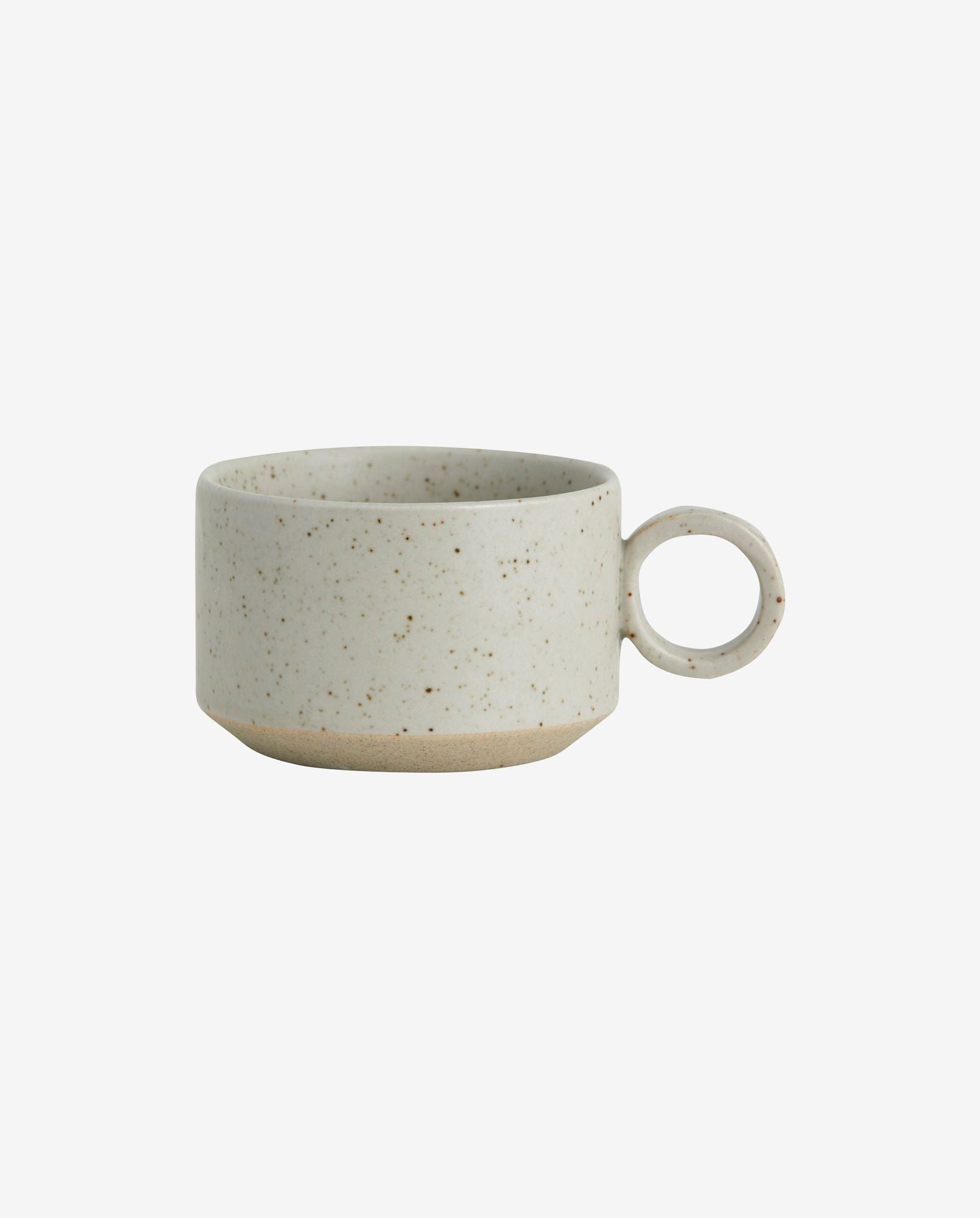 Minimalist speckled ceramic cup with round handle and beige base on white background