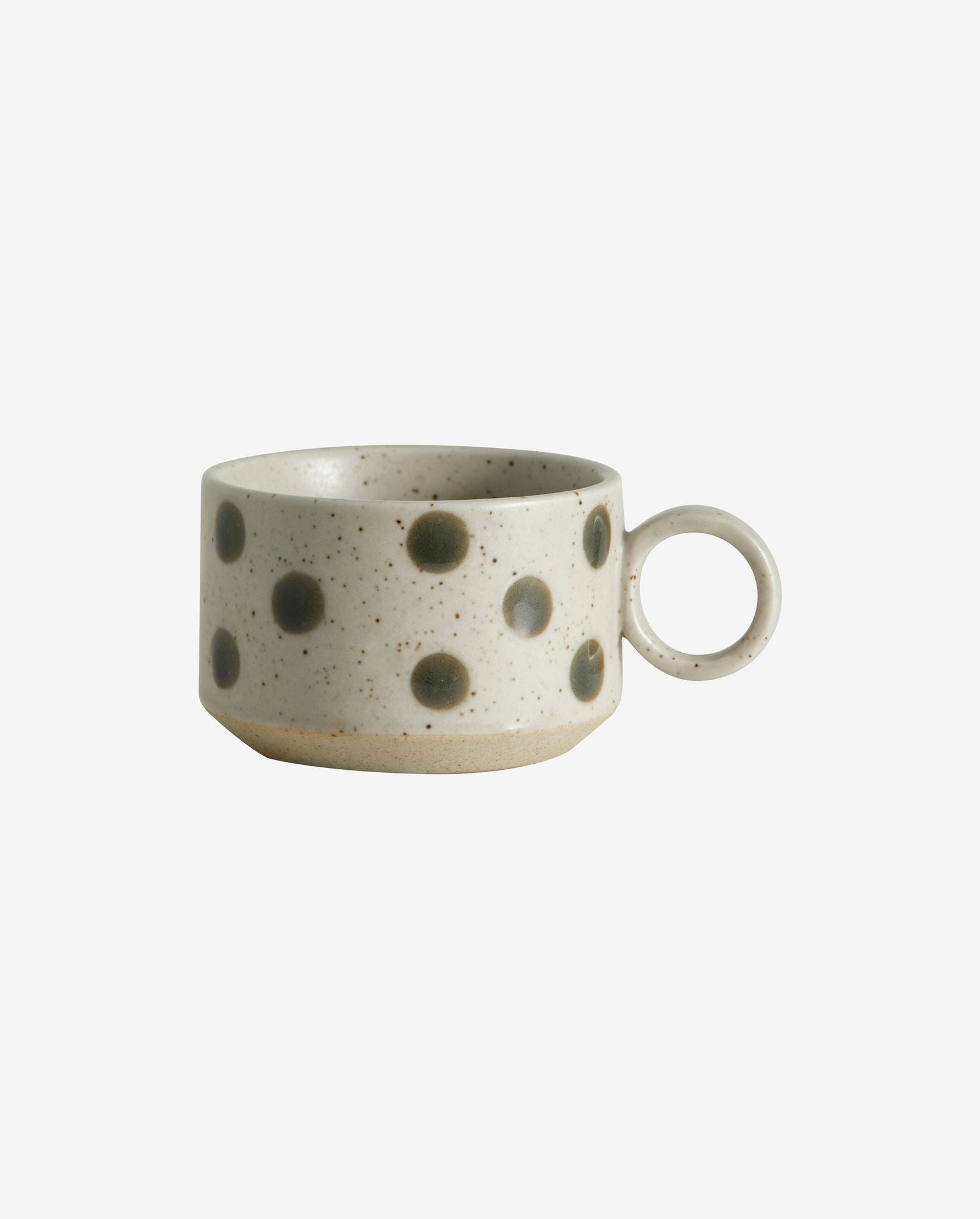 Ceramic coffee cup with gray polka dots and a round handle on white background