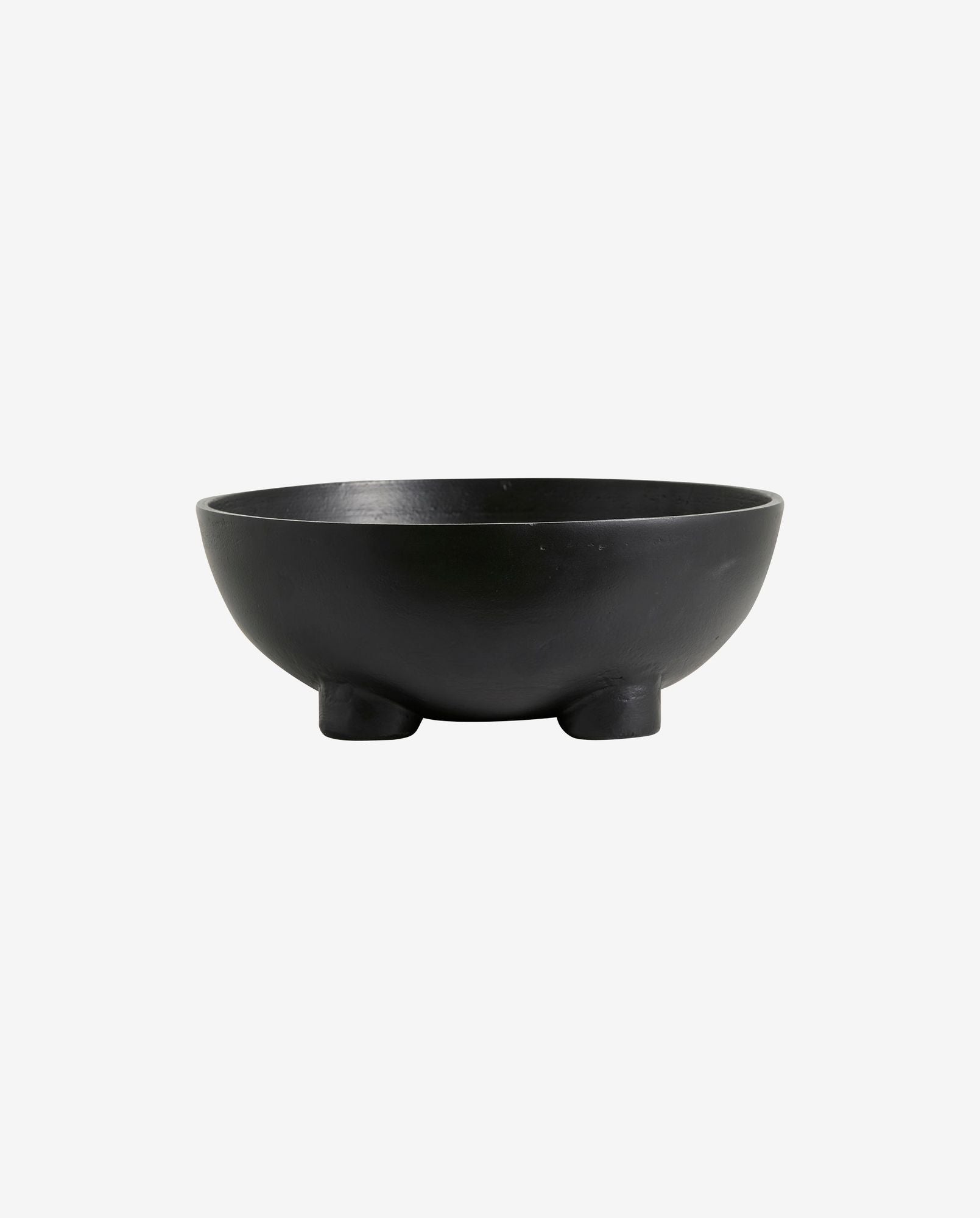 Black ceramic bowl with three short rounded feet on white background