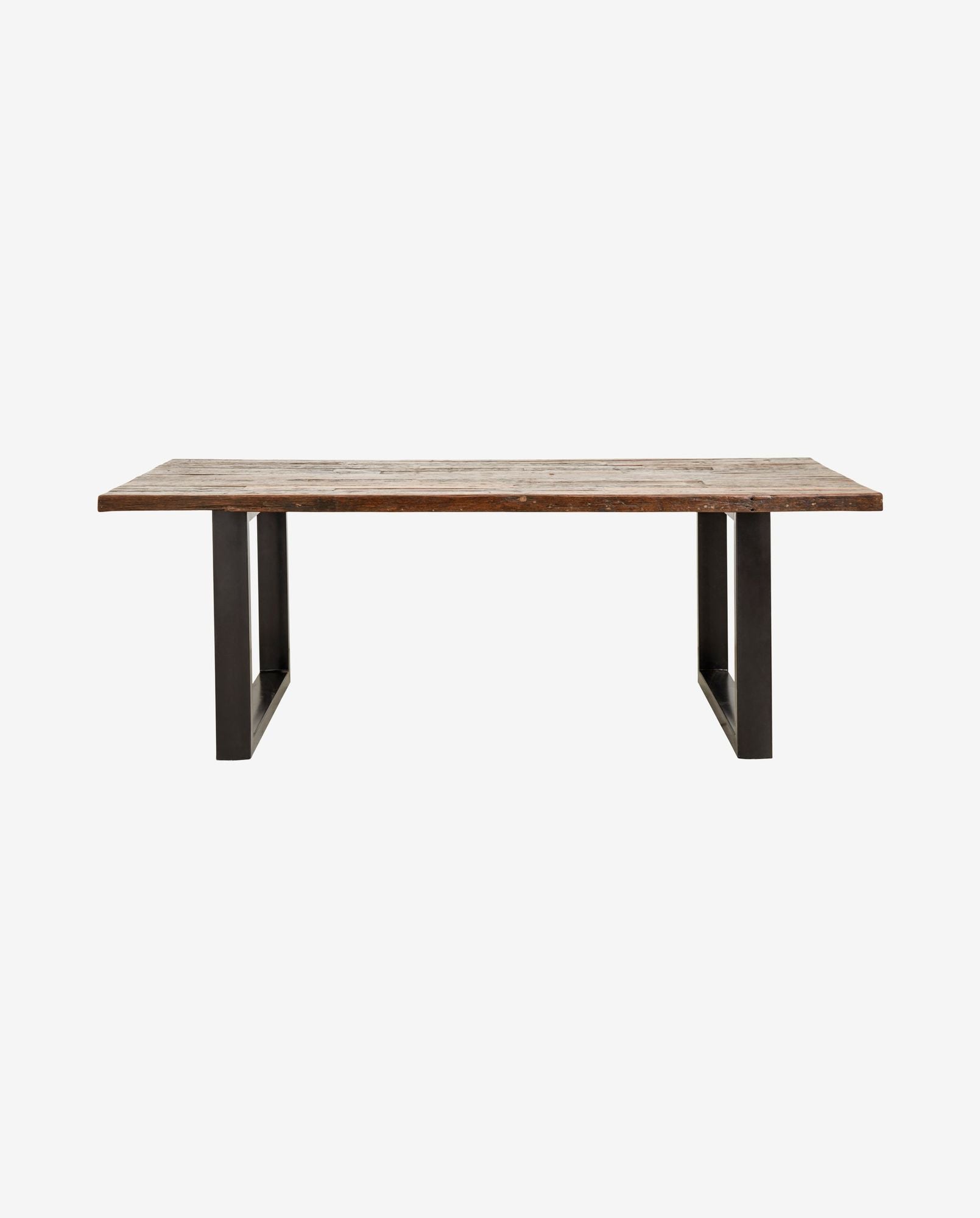 Rustic wooden dining table with thick metal legs, industrial farmhouse style