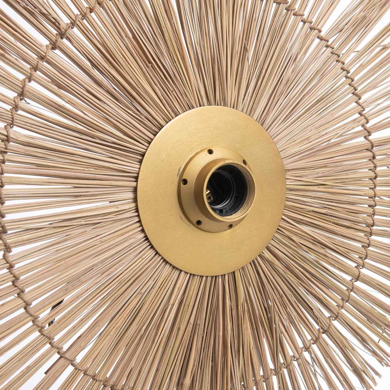 The Beausoleil Wall Lamp in natural gold, featuring a medium-sized handwoven grass shade with subtle brass detailing