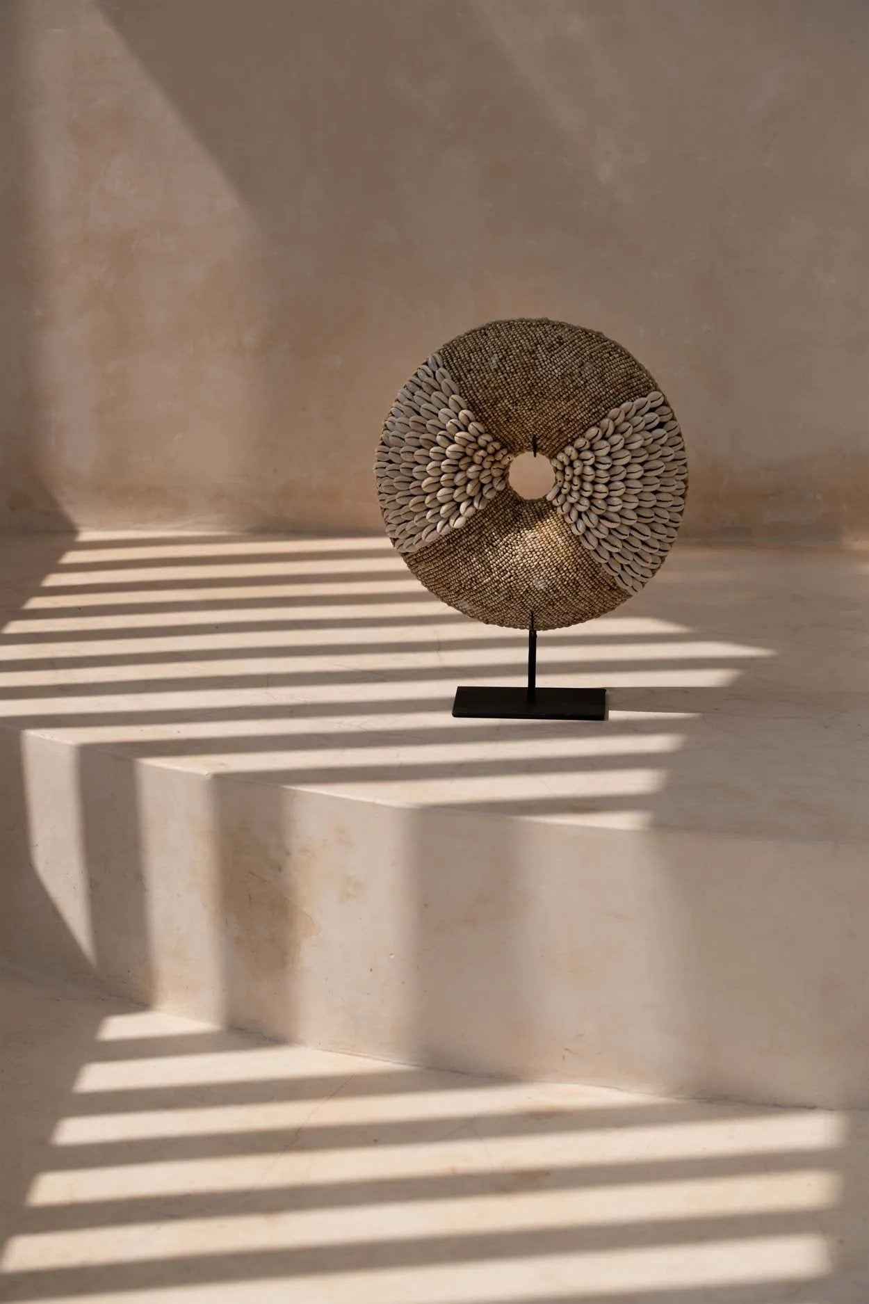 White shell display stand with playful circular design