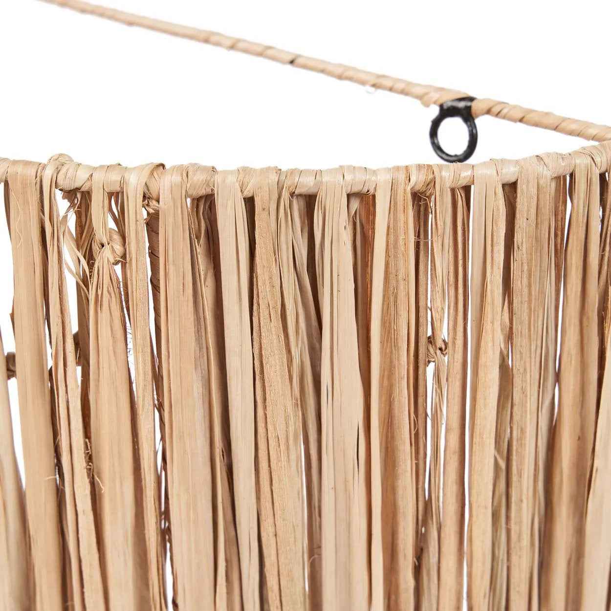 Handmade wall light with natural tones, blending seamlessly with wood and stone in a boho-styled living area or outdoor retreat.