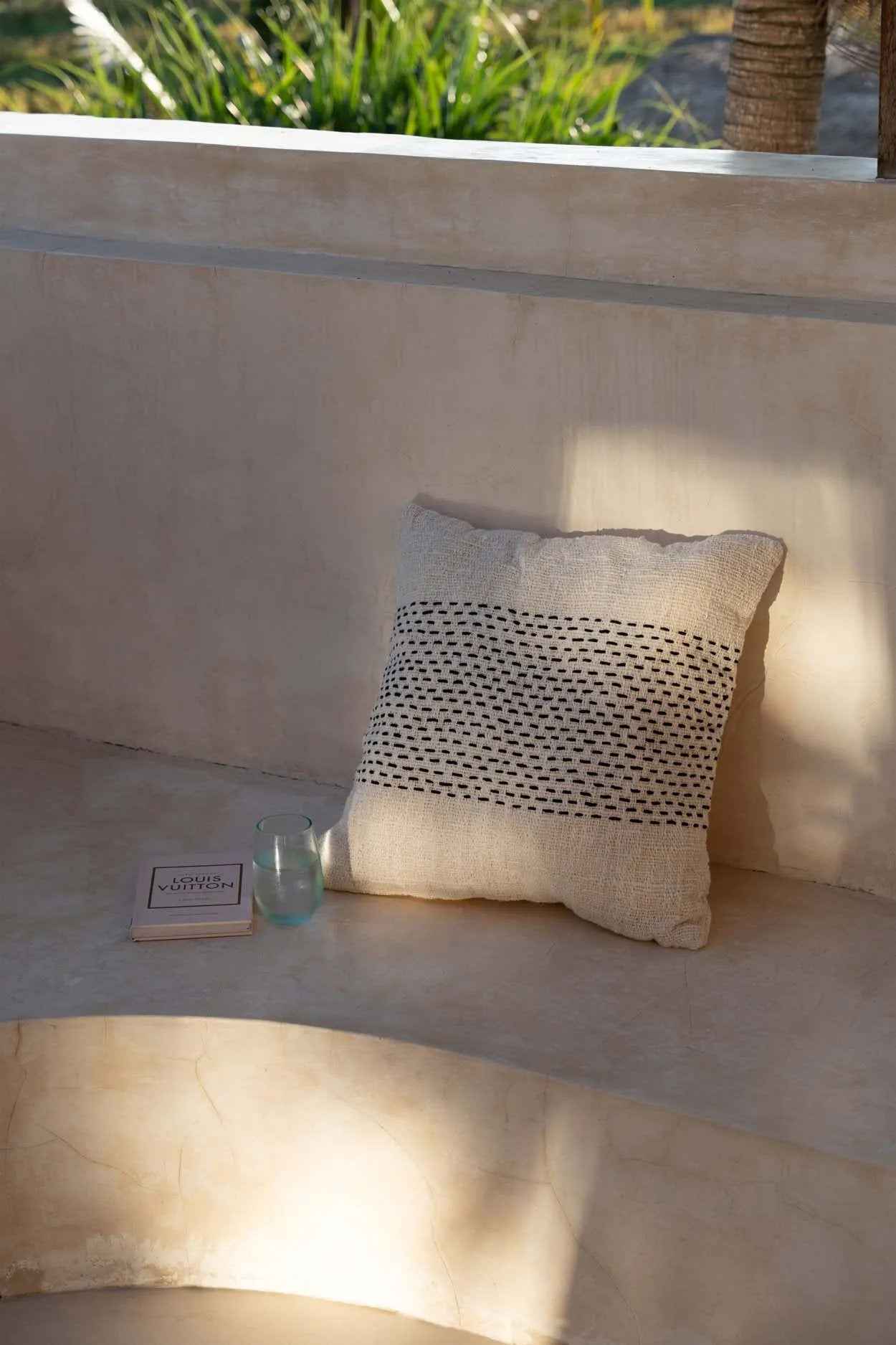 Stylish black cotton cushion cover for bed, adding a cozy touch