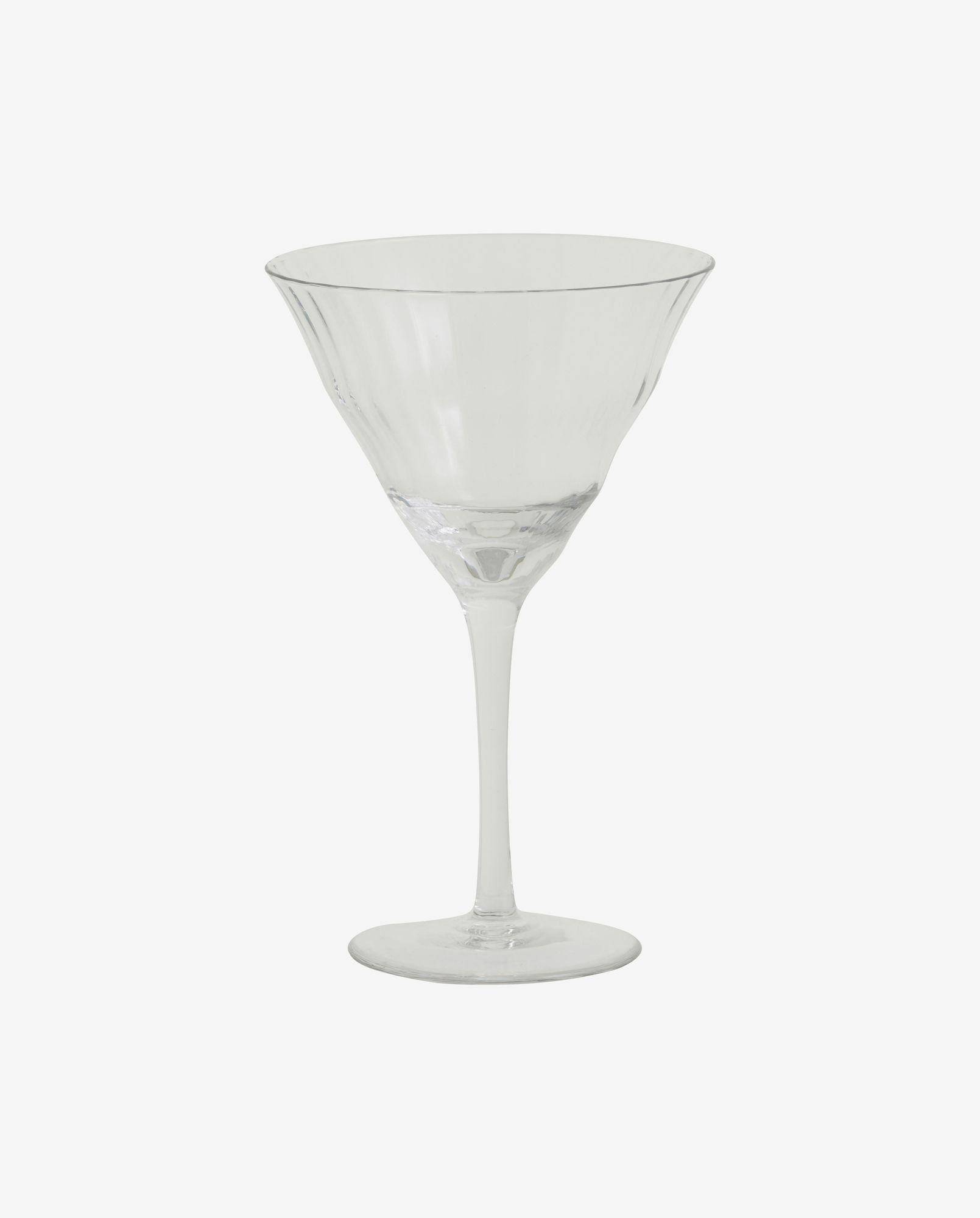Clear martini glass with flared rim and textured design on a white background