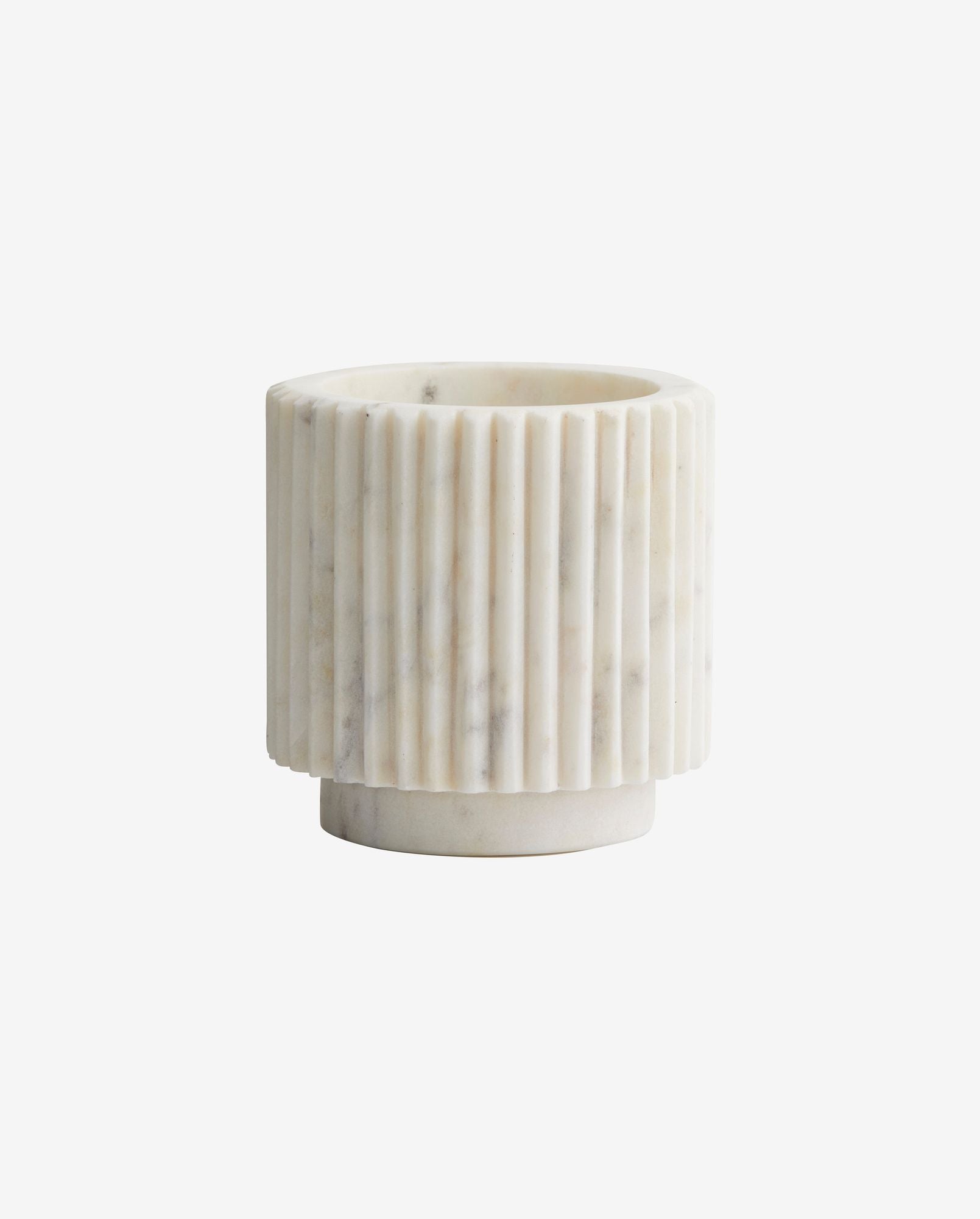 White marble planter with vertical ribbed texture and round base on white background