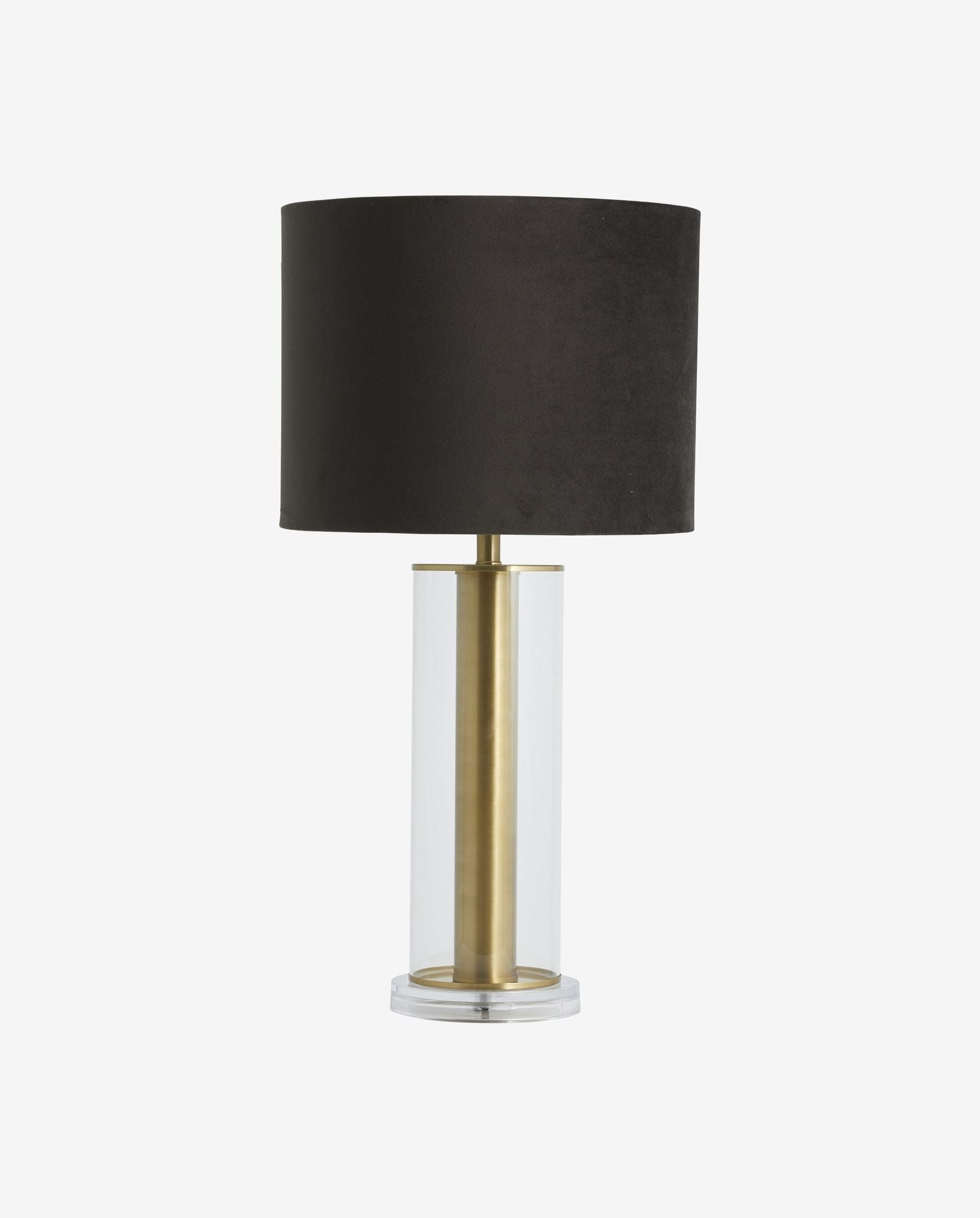 Modern table lamp with black fabric shade and clear glass base featuring brass accents