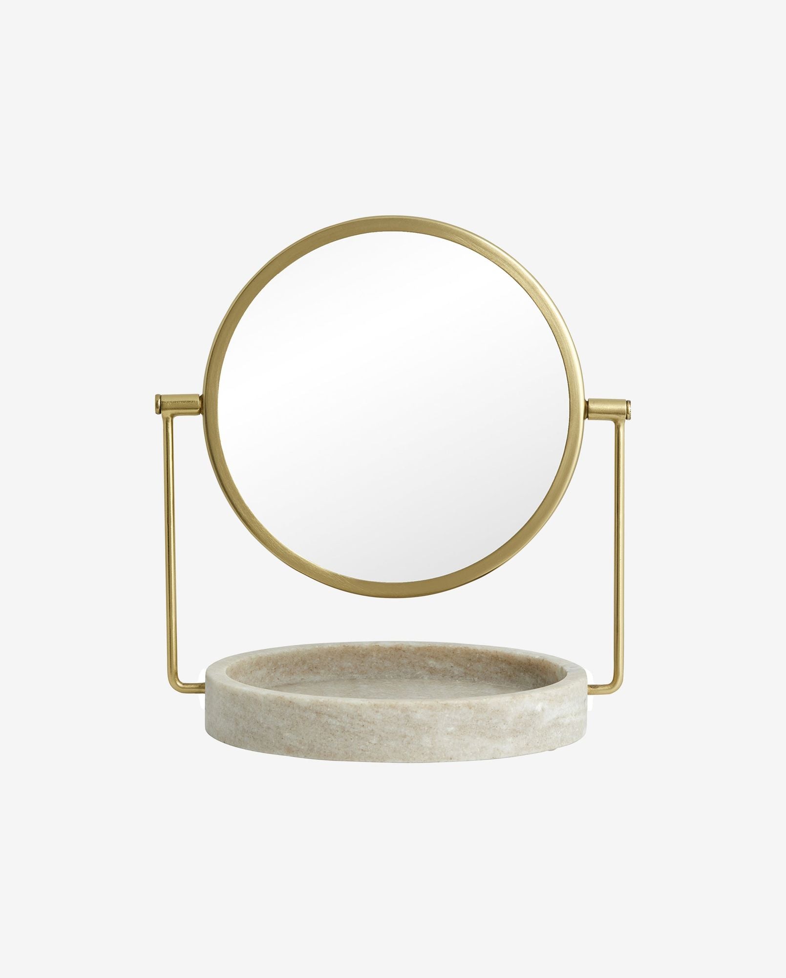 Round vanity mirror with gold frame and beige marble tray base on white background