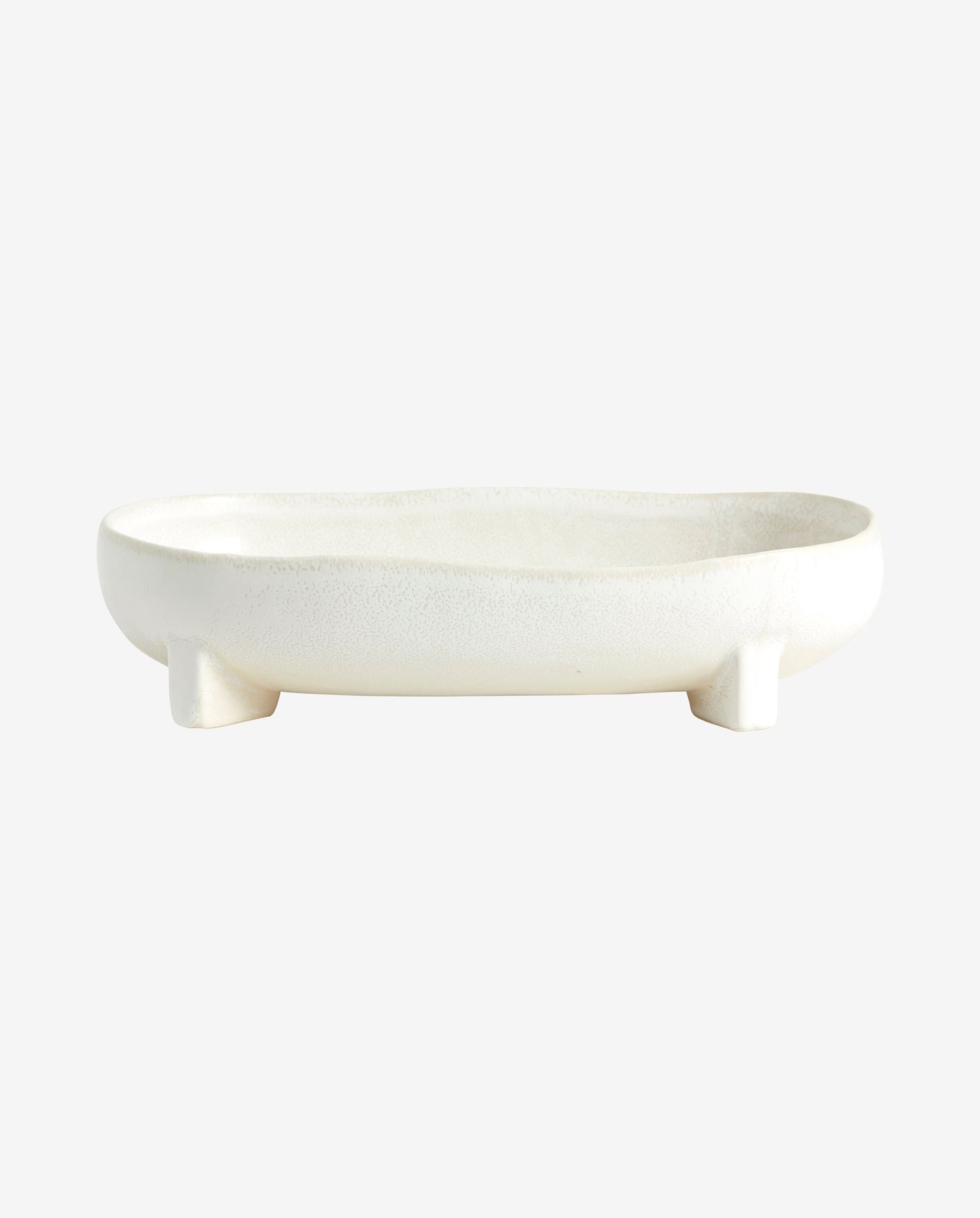 white ceramic soap dish with curved edges and four small legs on white background