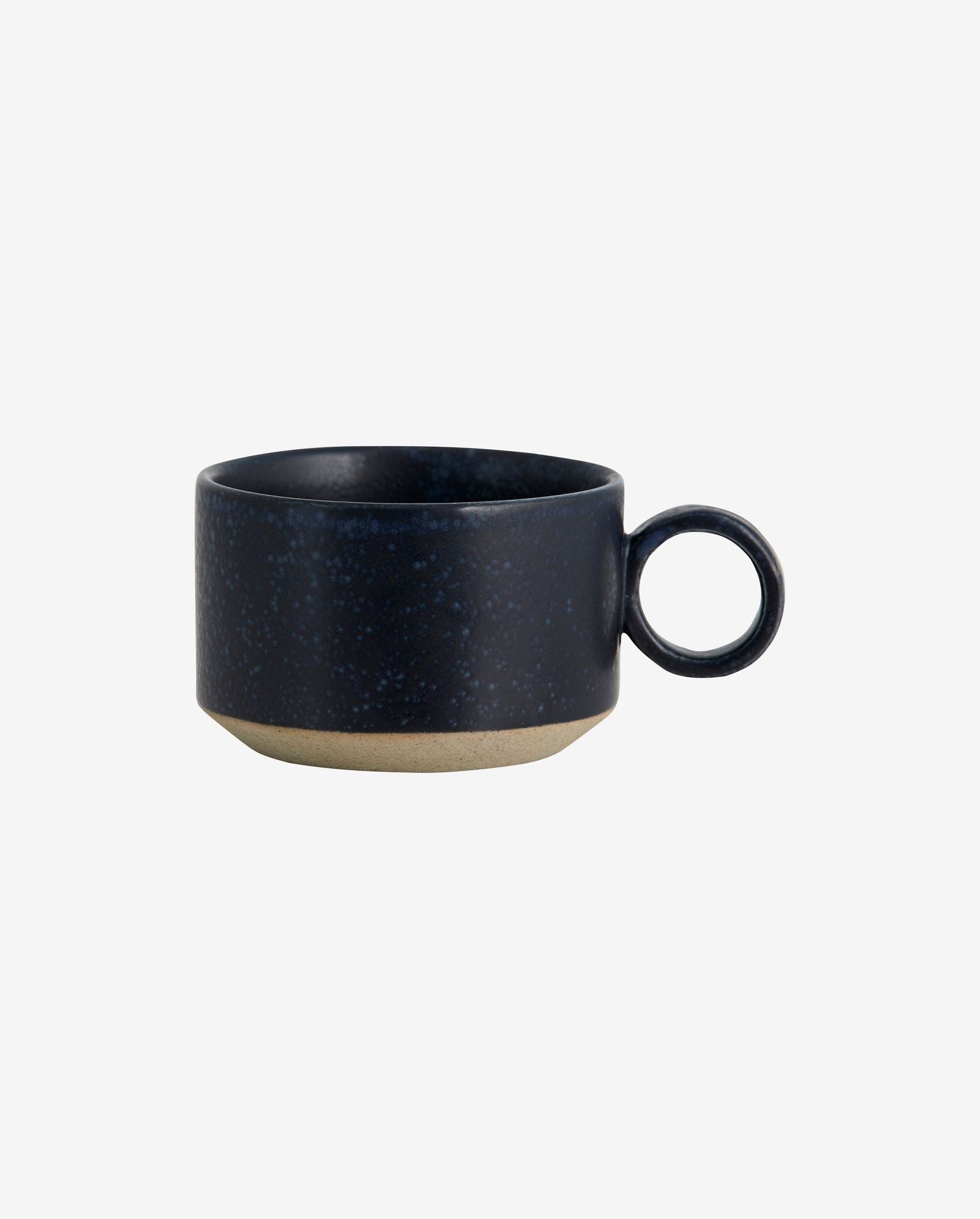 Dark blue speckled ceramic coffee cup with round handle and unglazed base