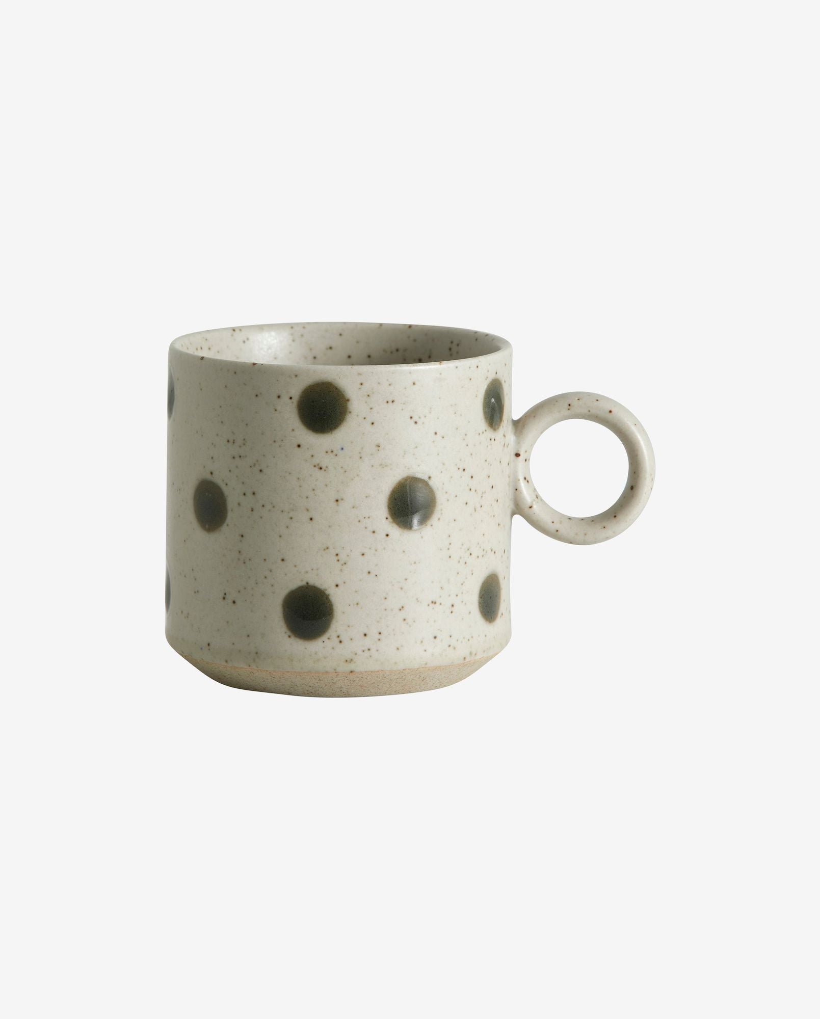 Speckled ceramic coffee mug with black polka dots and round handle on white background